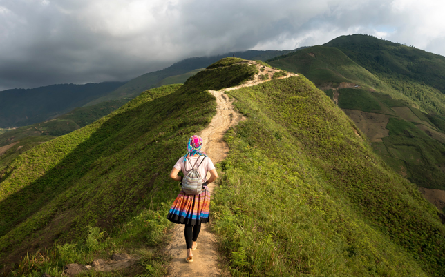 The photograph illustrates a male figure engaged in jogging on a hillside, distancing himself from the onlooker.